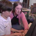 teacher giving child piano lesson