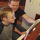 child enjoying private piano lesson in home