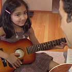 child enjoying guitar lesson in home